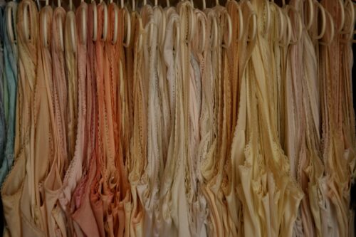 a bunch of lingerie hanging on a rack