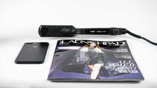 black corded hair flat iron beside magazine