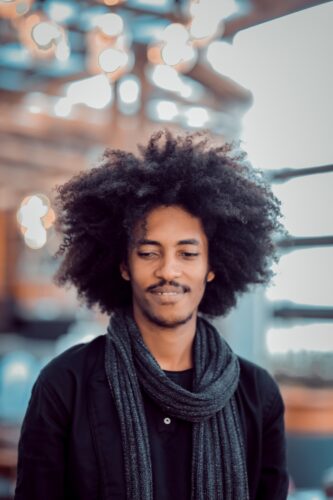 man wearing black shirt and gray scarf